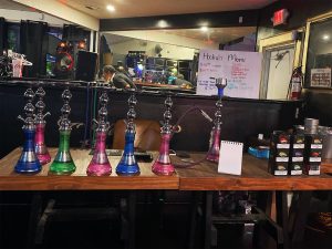 Close-up of hookah flavor preparation in club VIP section